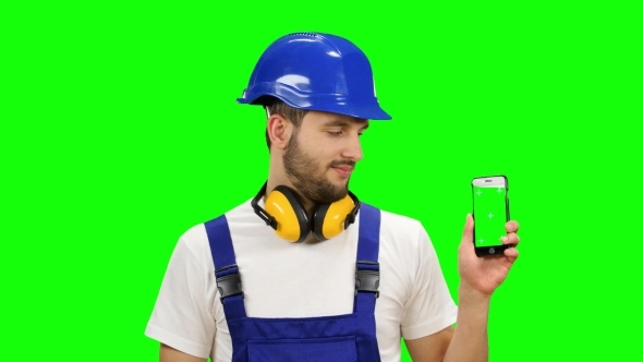 Builder Holds a Phone in His Hands and Shows a Thumbs up on Green Screen