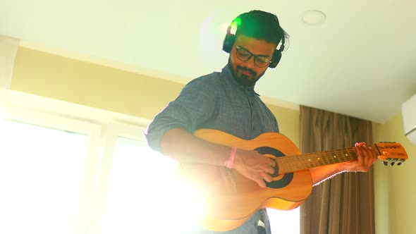 Indian Man is Playing the Guitar and Singing Favourite Song