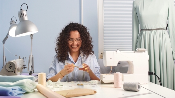 Seamstress Sewing Garment on Sewing Machine in Room. Clothers Designer.