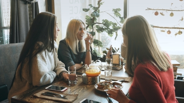 Four Female Friends Enjoying in Talking at Cafe