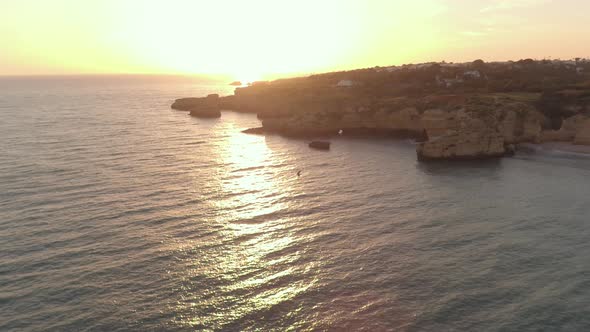 Aerial view of the ocean shore at sunset