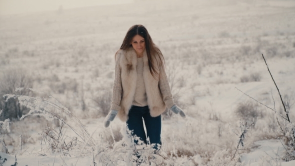 Beautiful Girl Walking on Snowy Road