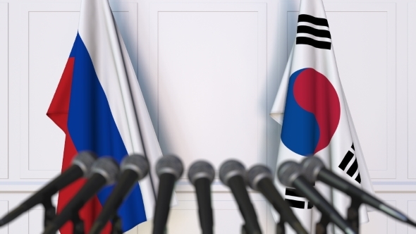 Flags of Russia and Korea at International Press Conference alt