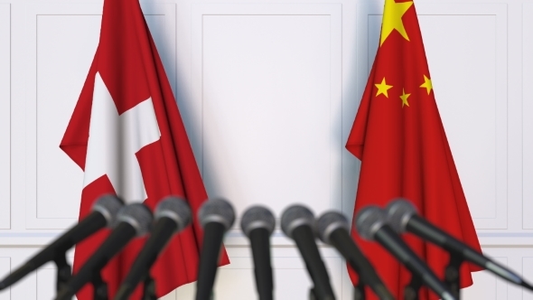 Flags of Switzerland and China at International Press Conference alt
