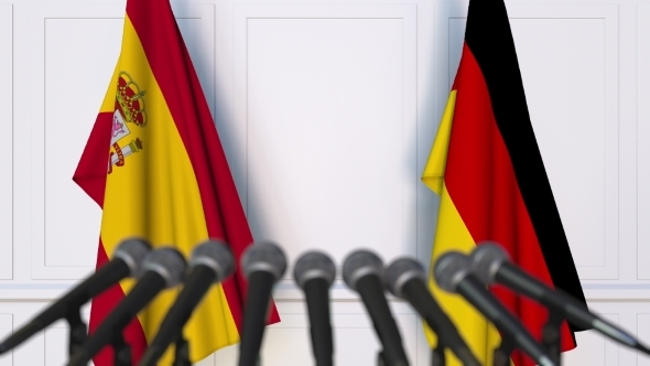 Flags of Spain and Germany at International Press Conference alt