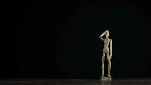Stopmotion Wooden Figure Dummy in Studio on Black Background Salutes and Marches