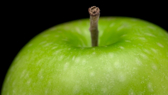 Beautiful, Green Apple Spinning on Black Background