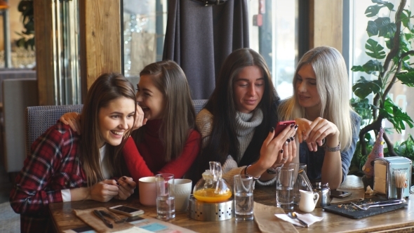 Communication and Friendship Concept - Smiling Young Women with Coffee Cups at Cafe