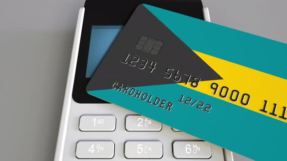 Plastic Bank Card with Flag of Bahamas and POS Terminal