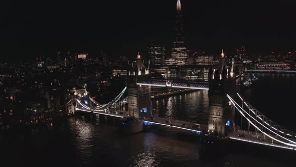 Aerial View to the Illuminated Tower Bridge and Skyline of London at Night UK