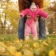 Baby with His Father Walk with Their Feet on Autumn Leaves - VideoHive Item for Sale
