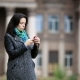 Charming Young Woman Standing in the Middle of the Park, Taping on Her Smart Phone - VideoHive Item for Sale