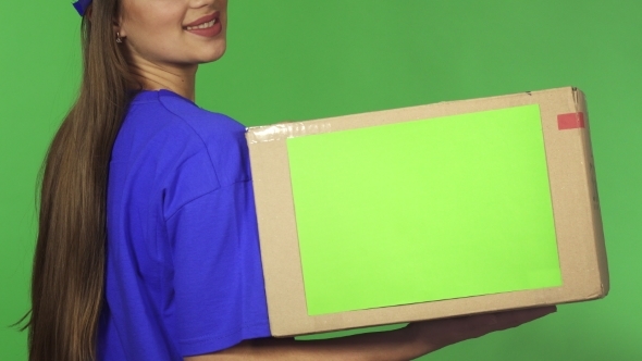 Cropped Rearview Shot of a Smiling Delivery Woman Holding Cardboard Box