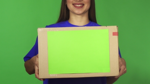 Cropped Shot of a Delivery Woman Smiling Holding Carboard Box with Copyspace
