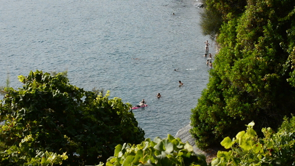 People Bathing in a Little Beach