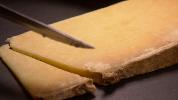 Hard French Cheese Parmesan Cut on a Board