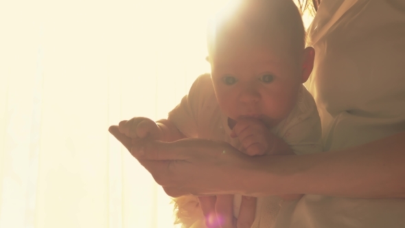 Mother Holding Her Newborn Baby Girl in Hands