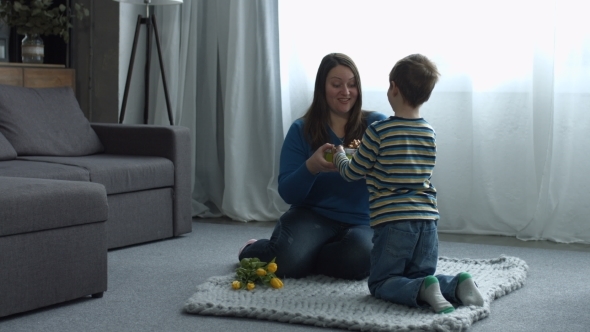 Cute Liitle Son Giving a Gift To Her Happy Mother