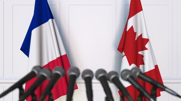 Flags of France and Canada at International Press Conference alt