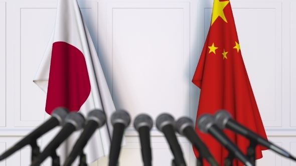 Flags of Japan and China at International Press Conference alt