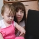 Young Mother with a Child Working at a Computer - VideoHive Item for Sale