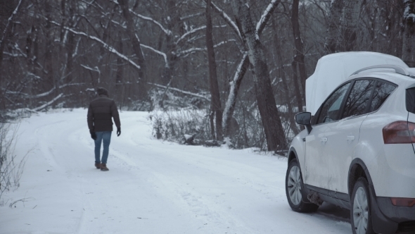 Man with Broken Car on Winter Road