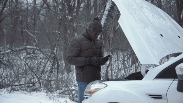 Man with Broken Car in Wintertime