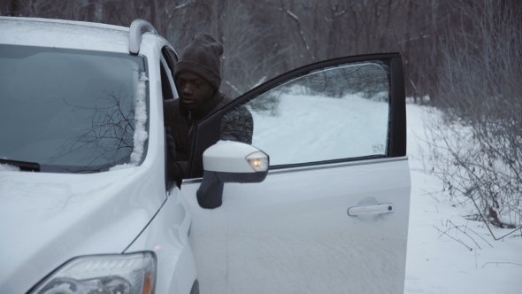 Man Jumping-start Car in Wintertime