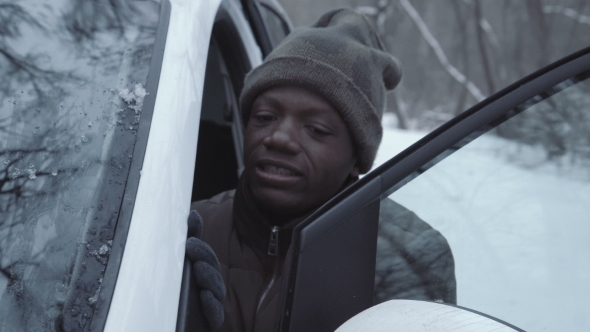 Man Jumping-start Car in Wintertime