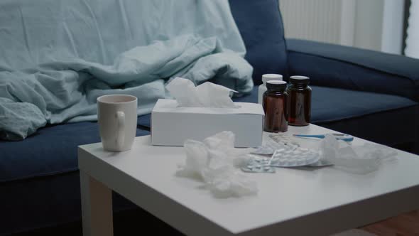 Close Up of Coffee Table with Medicine and Bottle of Pills