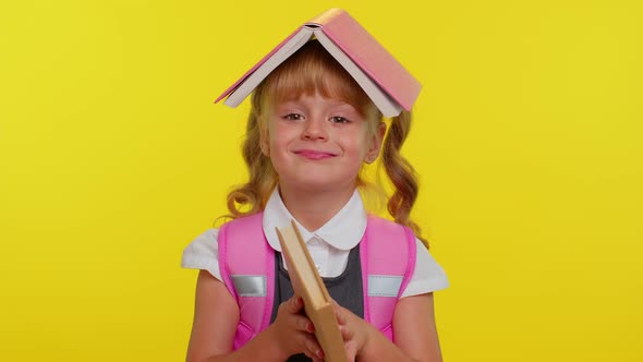 Joyful Funny Schoolgirl Kid with Book on Head Making Playful Silly Facial Expressions Fooling Around