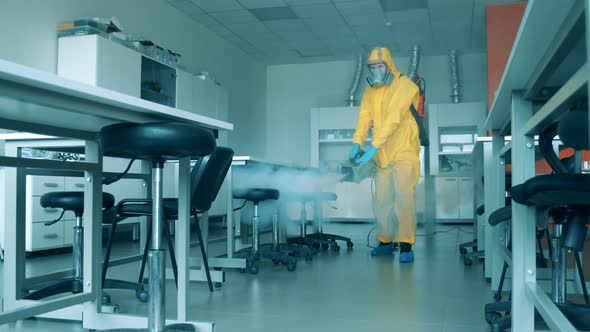 Sanitation Worker Sprays Laboratory Room. Covid19, Coronavirus Concept.