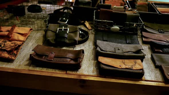 Various types of leather bag on table