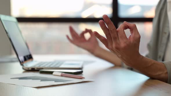 Employee Meditates Breathing Deeply at Workplace in Office