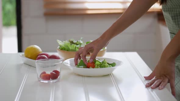 Asian woman ingredients for making a salad, vegetable, strawberry cooking a healthy.