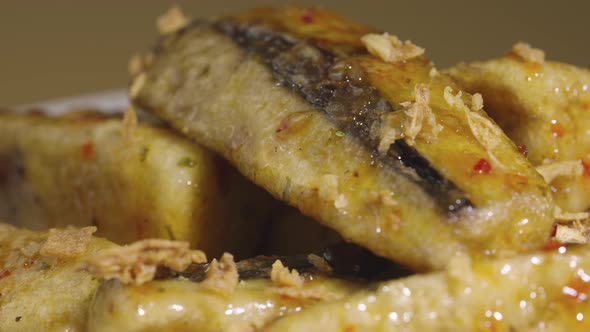 Tempura Aubergine Slices with Spicy Spices and Cane Sugar Syrup on Grey Plate Rotating Close Up