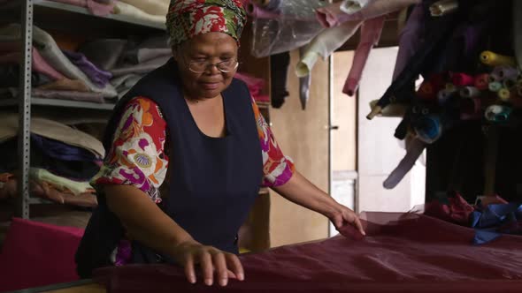 Mixed race woman working at a hat factory