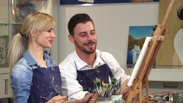 Happy Couple Painting a Picture Together on a Date at Art Studio