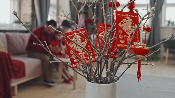 Chinese New Year Ornaments on Branches in Vase