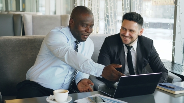 Cheerful African American Businessman in Formal Clothes Discussing Business Project