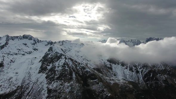 Flying Through Clouds Between Mountains