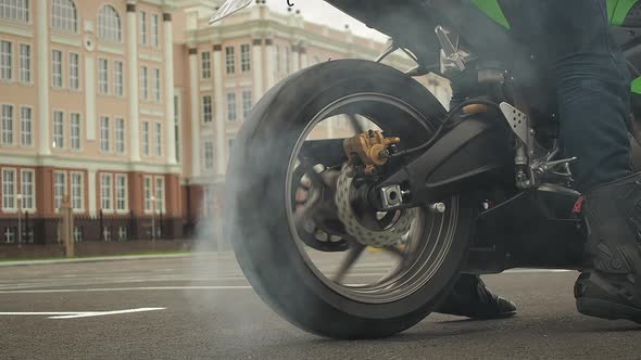 Biker on a Motorcycle Drifts in Smoke