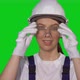 Woman Builder in Blue Overalls and White Hard Hat Put on Protective Glasses - VideoHive Item for Sale