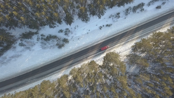 Snowy Road with a Moving Car in Winter