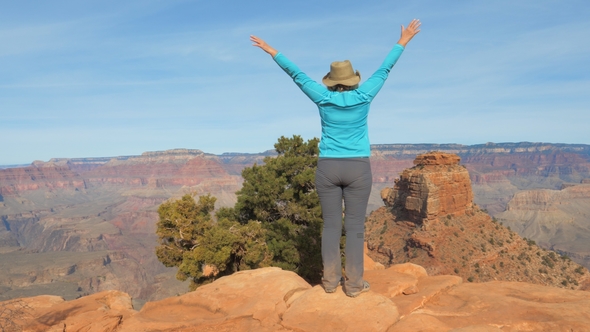 Woman Hiking In Grand Canyon Is Coming To The Observation Point And Arms Up