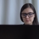 Young Brunette Businesswoman in Office Suit and Glasses Works with Laptop. - VideoHive Item for Sale