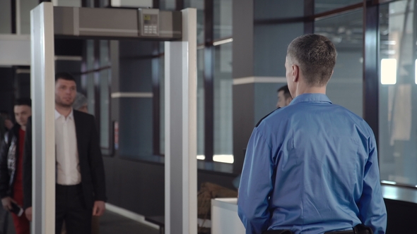 Businessman Passing Border Control with Metal Detector