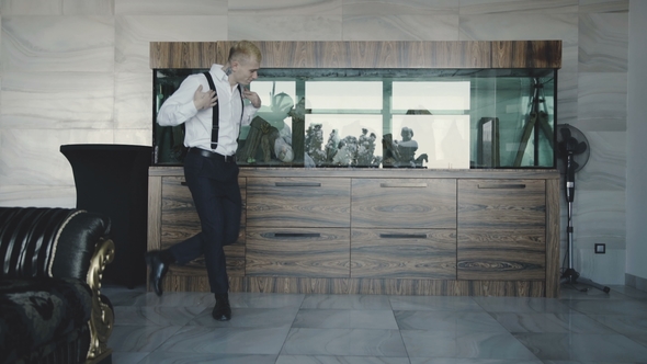 Glamorous Young Man in Stylish Suit Dancing in the Room