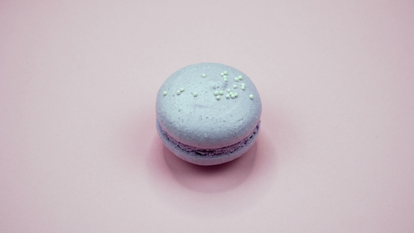 ROTATION: A Colorful Macaroons Are Rotating on a Pink Background