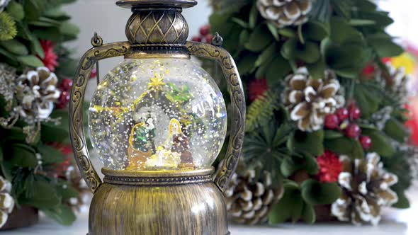 Snowglobe with child in the manger on Christmas background. Flat plane